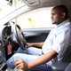 An Uber taxi driver sits in his car in Nairobi